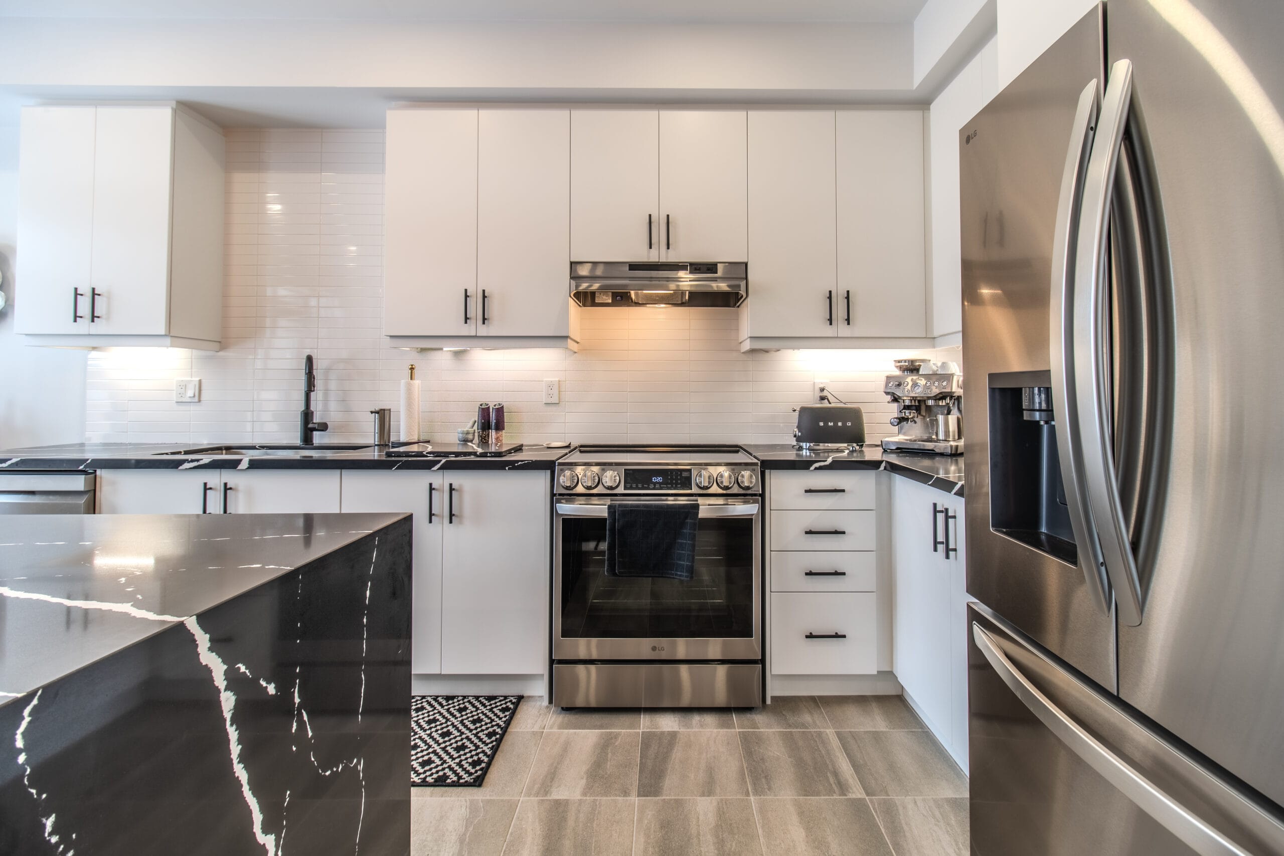 Renovated kitchen with black marble island in Vaughan